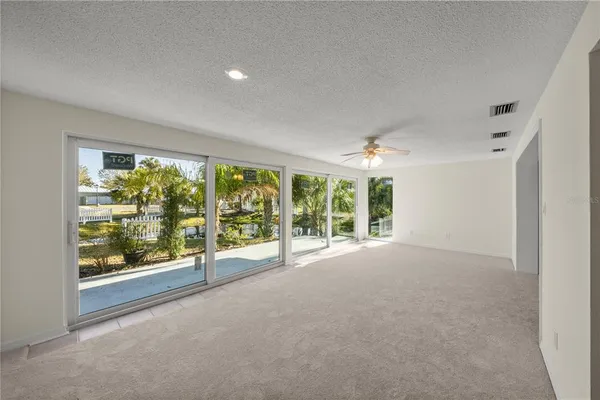 a view of a room with large windows and pool