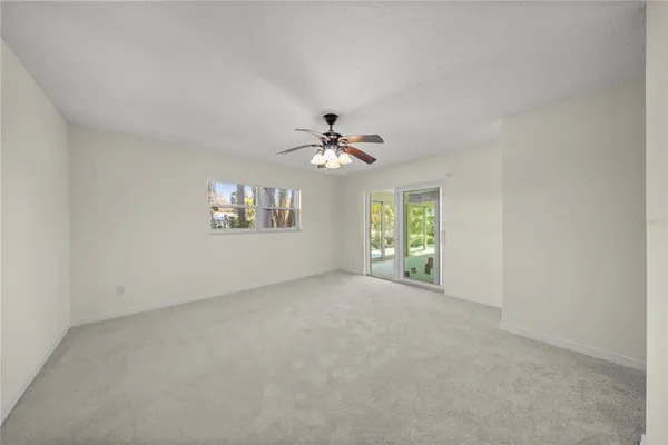 a view of a livingroom with a ceiling fan and window