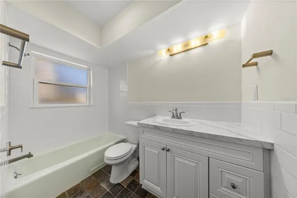 a bathroom with a sink a toilet and a bathtub