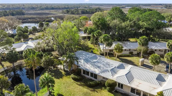 an aerial view of a house with a yard basket ball court and outdoor seating