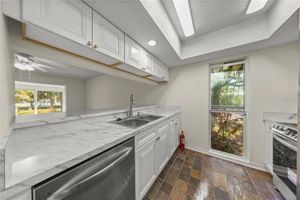 a view of a kitchen with a sink and dishwasher
