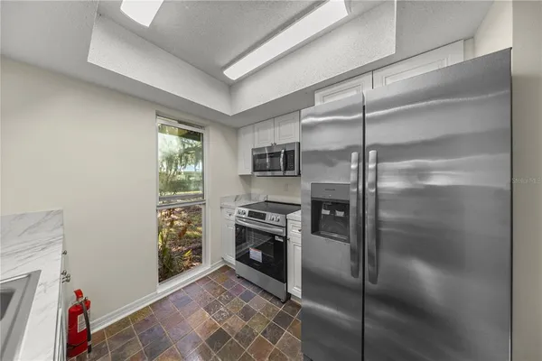 a kitchen with cabinets and stainless steel appliances