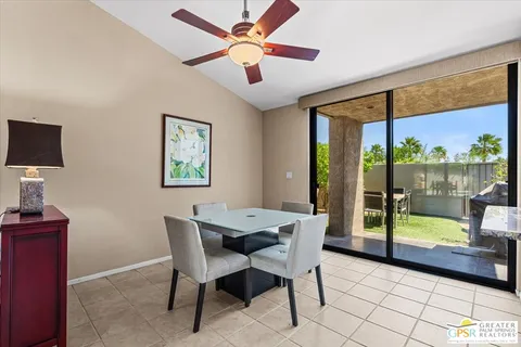 a dining room with furniture and a floor to ceiling window