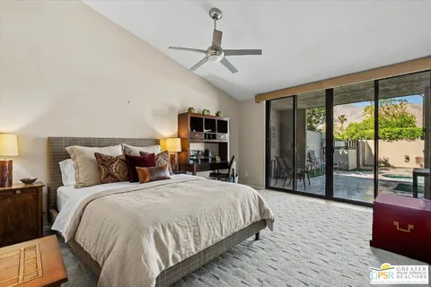 a large bedroom with a bed and large glass window
