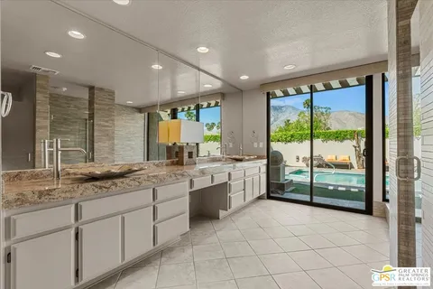 a large bathroom with a large tub and sink