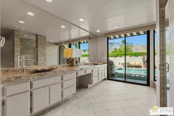 a large bathroom with a large tub and sink