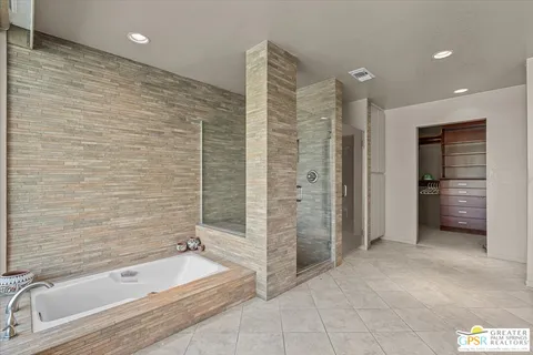 a bathroom with a tub a sink and a shower