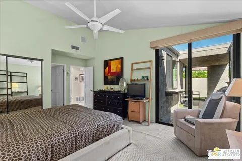 a bedroom with furniture and a flat screen tv