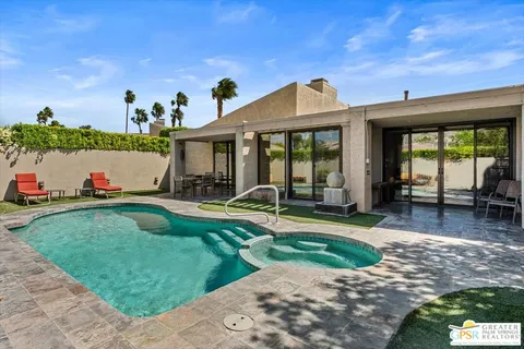 a view of a house with backyard porch and sitting area