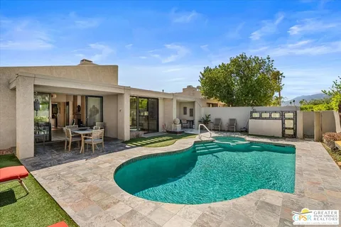 a view of a house with backyard porch and sitting area