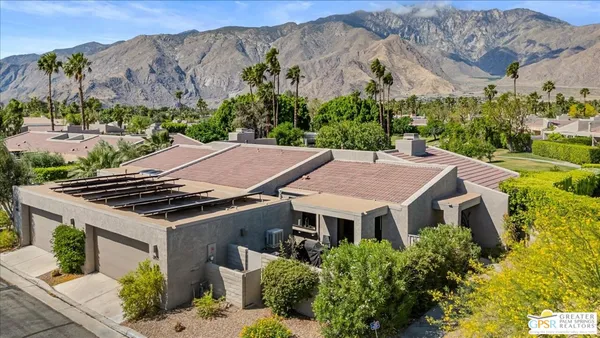 an aerial view of house with a garden