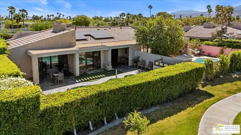 an aerial view of a house with swimming pool garden and outdoor seating