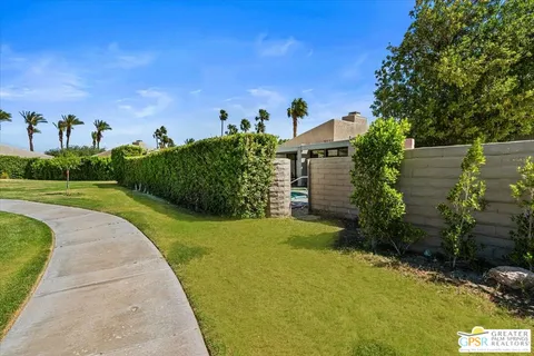 a view of a garden with a building in the background