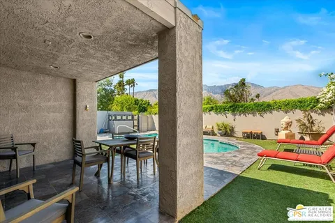 a view of a patio with table and chairs and potted plants