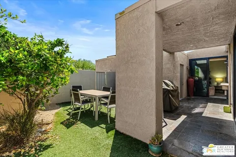 a patio with table and chairs