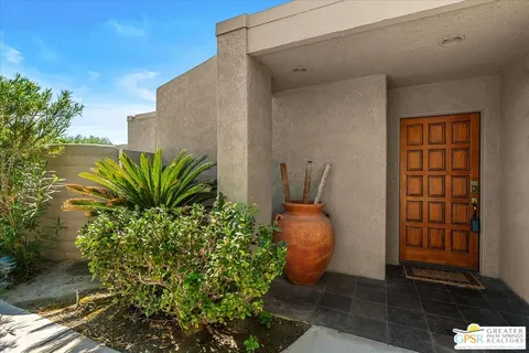 a potted plant sitting in front of a house