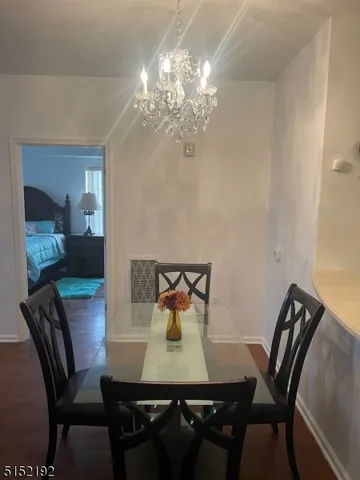 a view of a dining room with furniture and chandelier
