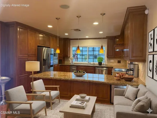 a living room with stainless steel appliances kitchen island granite countertop furniture and a view of kitchen