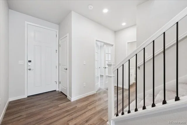 a view of a hallway with wooden floor