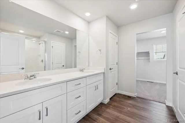 a bathroom with a double vanity sink and mirror