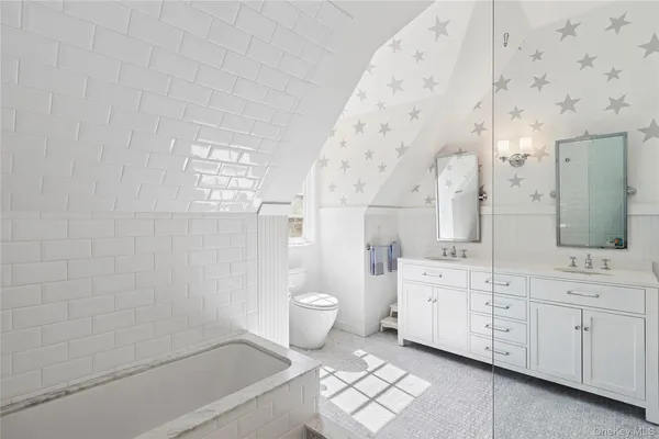 a bathroom with a granite countertop sink a toilet and bathtub