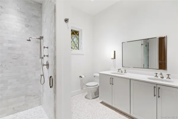 a bathroom with a toilet sink and mirror