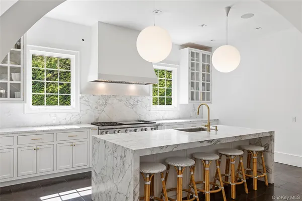 a kitchen with a sink cabinets and window