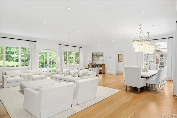 a living room with furniture and a chandelier