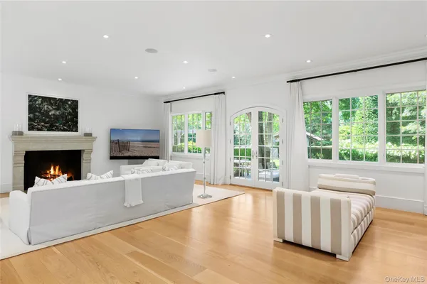 a living room with furniture a flat screen tv and a fireplace