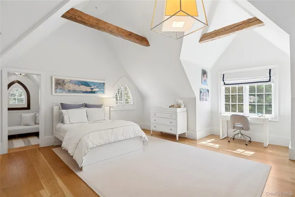 a bedroom with a bed a table and chair