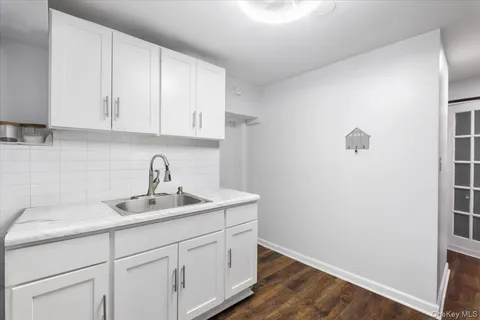 a kitchen with a sink and cabinets