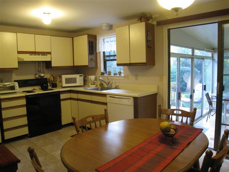 105 Nobadeer Road Centerville, MA 02632 - Photo 7 of 22 a kitchen with a sink appliances and cabinets