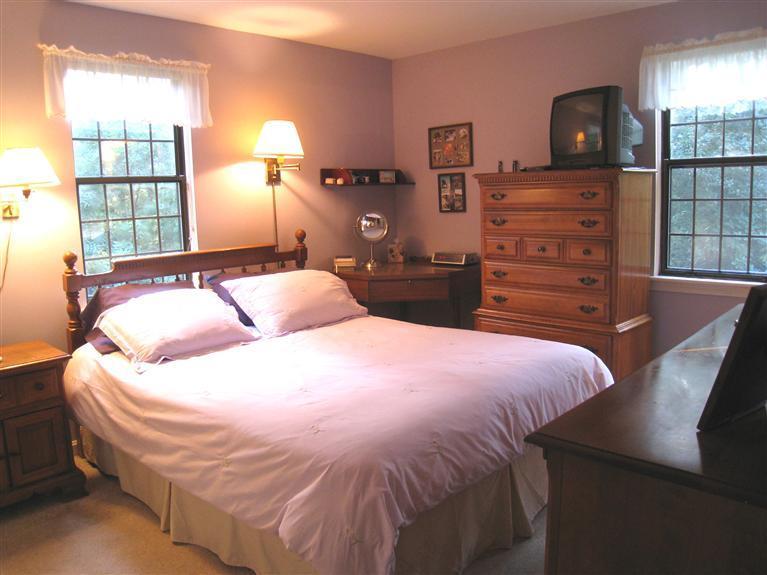 105 Nobadeer Road Centerville, MA 02632 - Photo 8 of 22 a bedroom with a bed and wooden floor