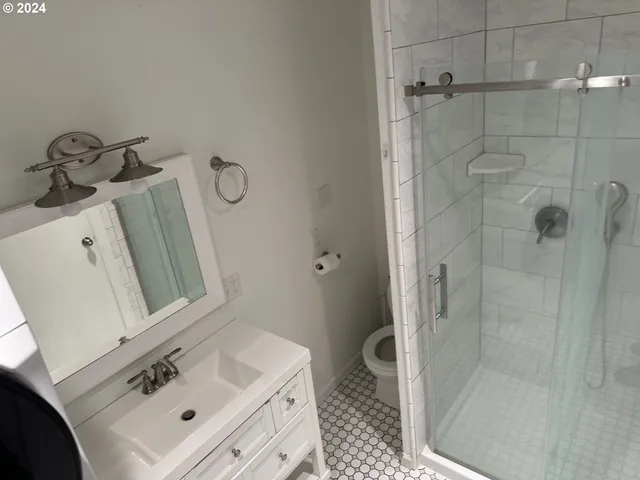 a bathroom with a sink toilet and shower