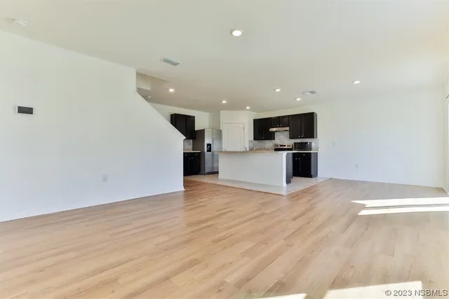 a view of a kitchen with a sink and a refrigerator