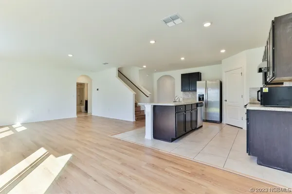 a kitchen with stainless steel appliances granite countertop a sink a stove and cabinets