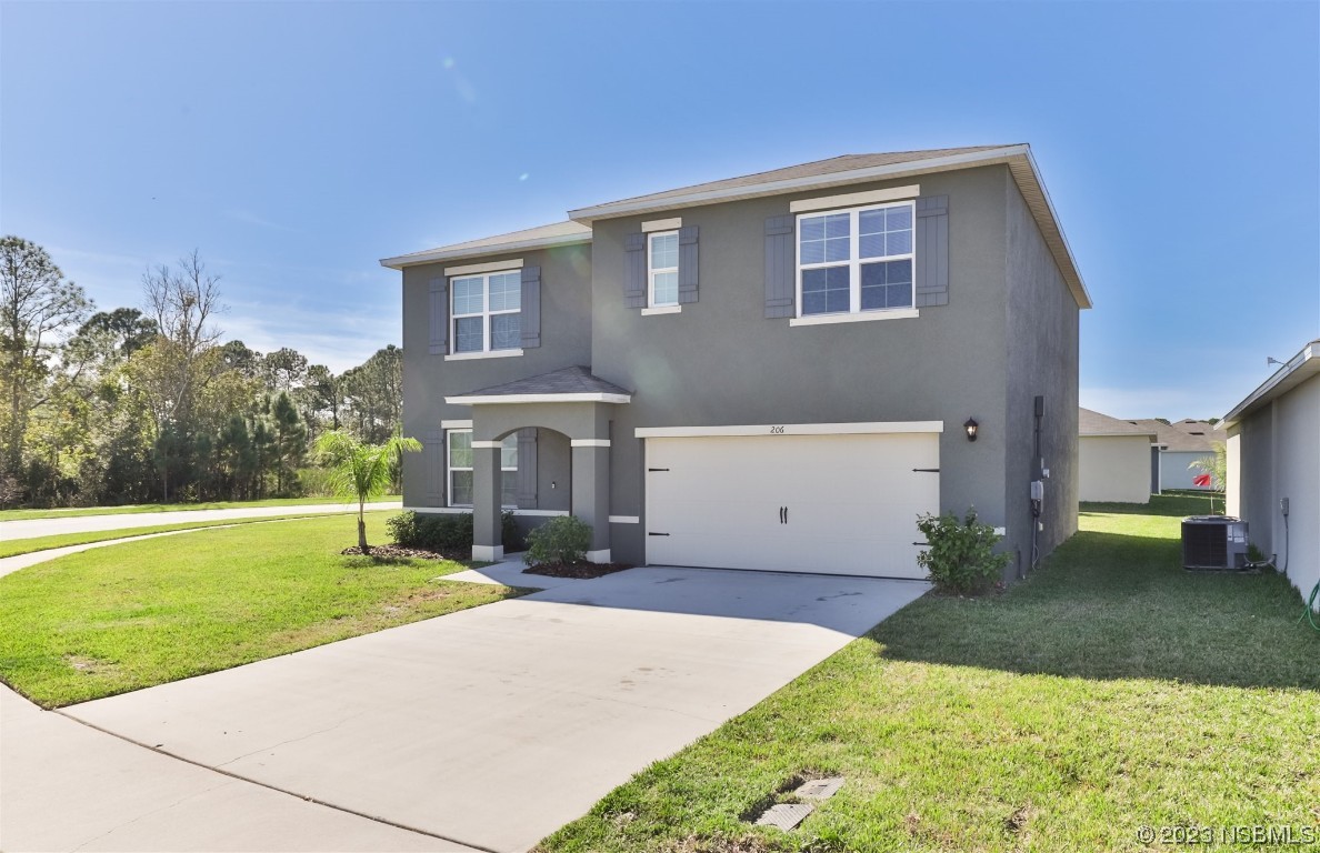 206 Old Mill Edgewater, FL 32141 - Photo 2 of 66 a front view of a house with a yard and trees