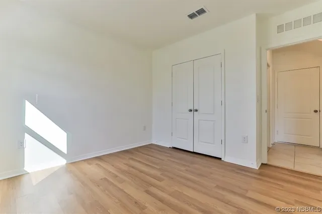 a view of hallway with wooden floor