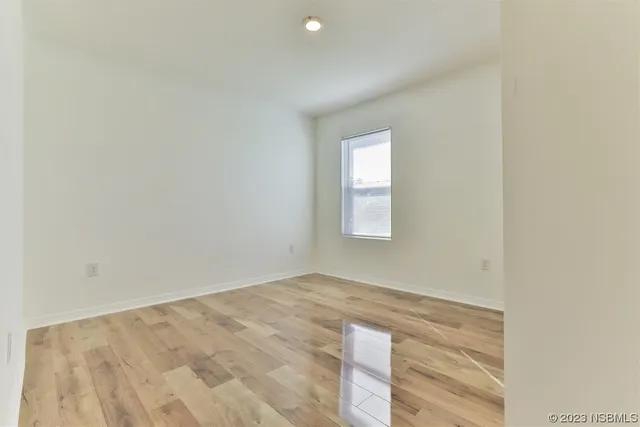 a view of a room with wooden floor and windows