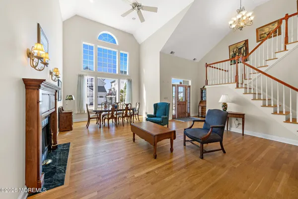 a view of a hallway with wooden floor and furniture