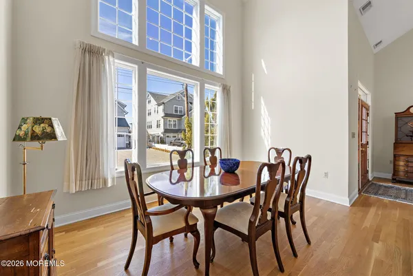 a kitchen with stainless steel appliances granite countertop a stove a sink and a refrigerator with wooden floor