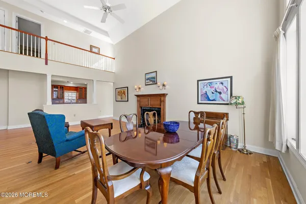 a kitchen with stainless steel appliances granite countertop a refrigerator a sink dishwasher a stove and a dining table with wooden cabinet