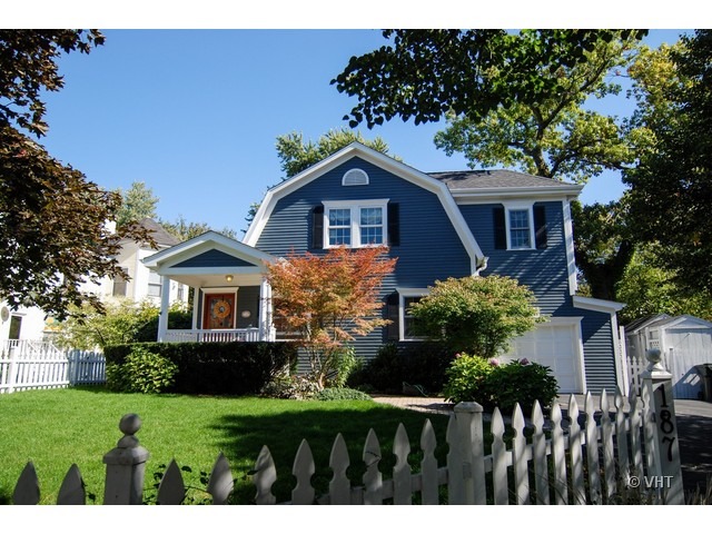 187 Ridge Avenue Winnetka, IL 60093 - Photo 1 of 18 a front view of a house with a garden