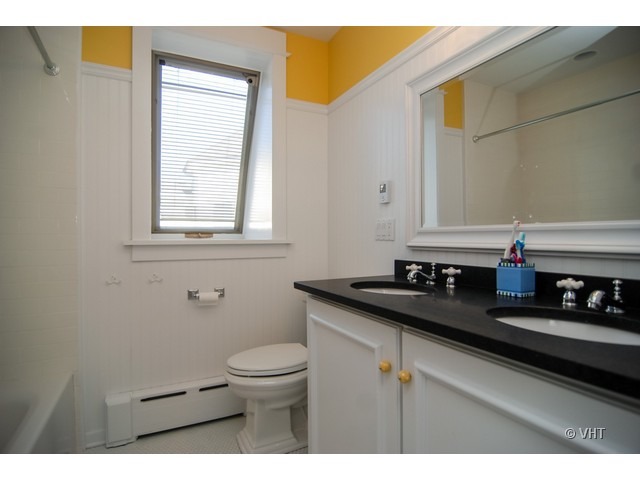 187 Ridge Avenue Winnetka, IL 60093 - Photo 12 of 18 a bathroom with a granite countertop sink a toilet and a mirror
