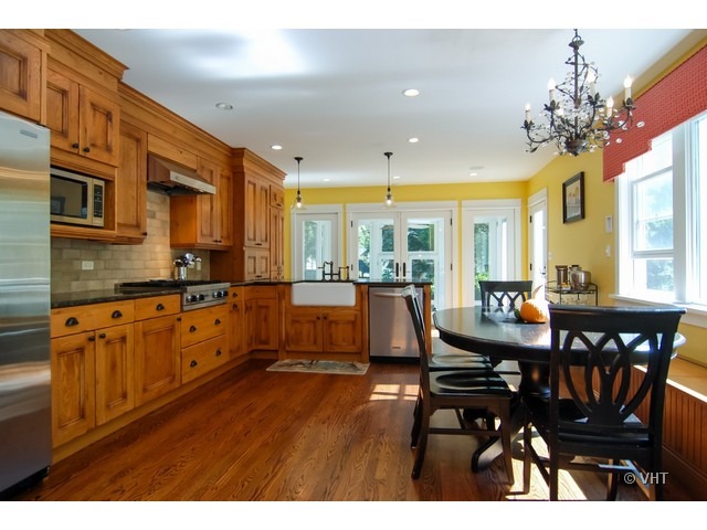 187 Ridge Avenue Winnetka, IL 60093 - Photo 4 of 18 a large kitchen with a table and chairs