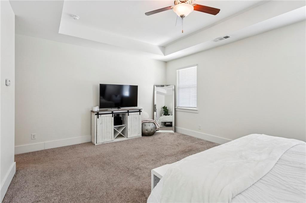 4006 Glendianne Way Powder Springs, GA 30127 - Photo 11 of 21 a bedroom with a bed and a flat screen tv