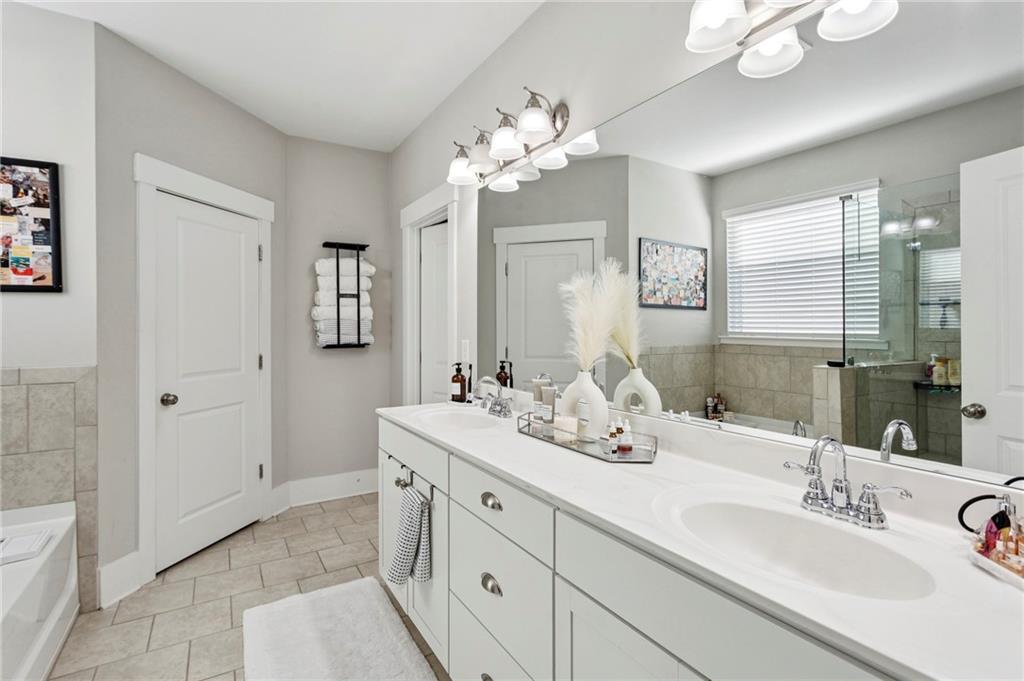 4006 Glendianne Way Powder Springs, GA 30127 - Photo 12 of 21 a bathroom with a double vanity sink mirror and