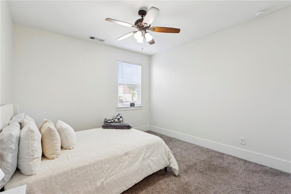 4006 Glendianne Way Powder Springs, GA 30127 - Photo 15 of 21 a bedroom with a white bed and a chandelier