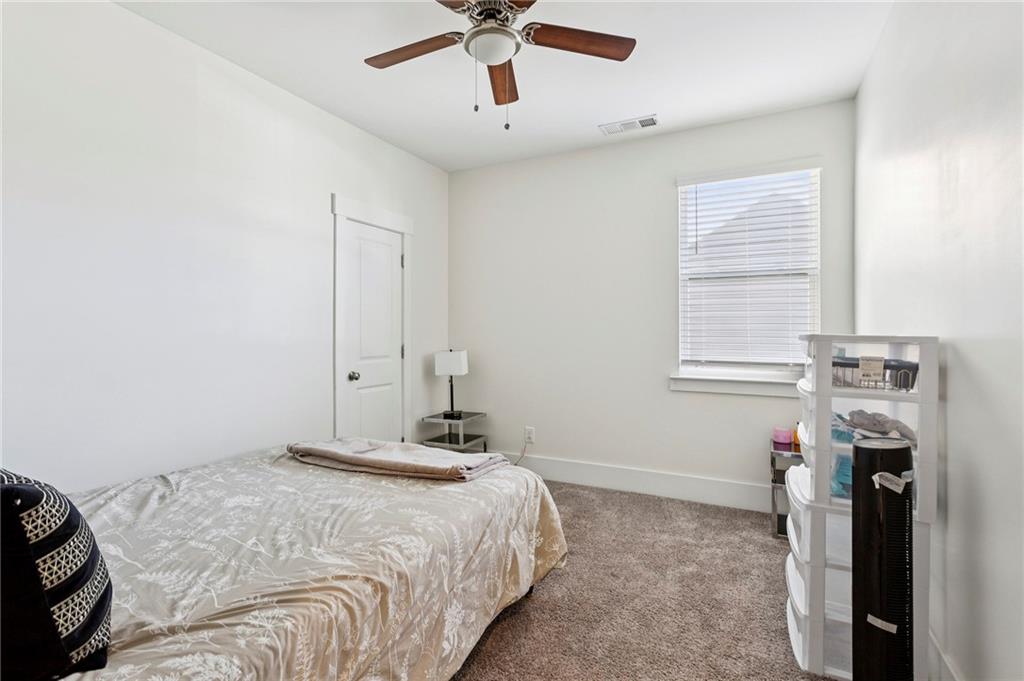4006 Glendianne Way Powder Springs, GA 30127 - Photo 17 of 21 a bedroom with a bed and a window