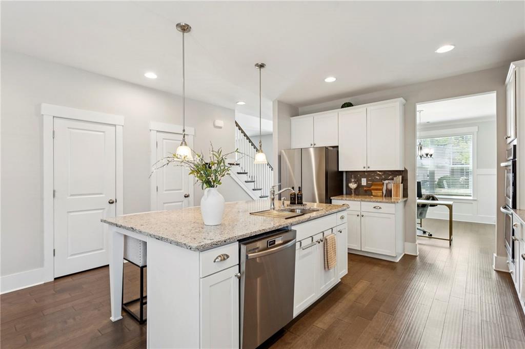 4006 Glendianne Way Powder Springs, GA 30127 - Photo 7 of 21 a kitchen with white cabinets and white appliances